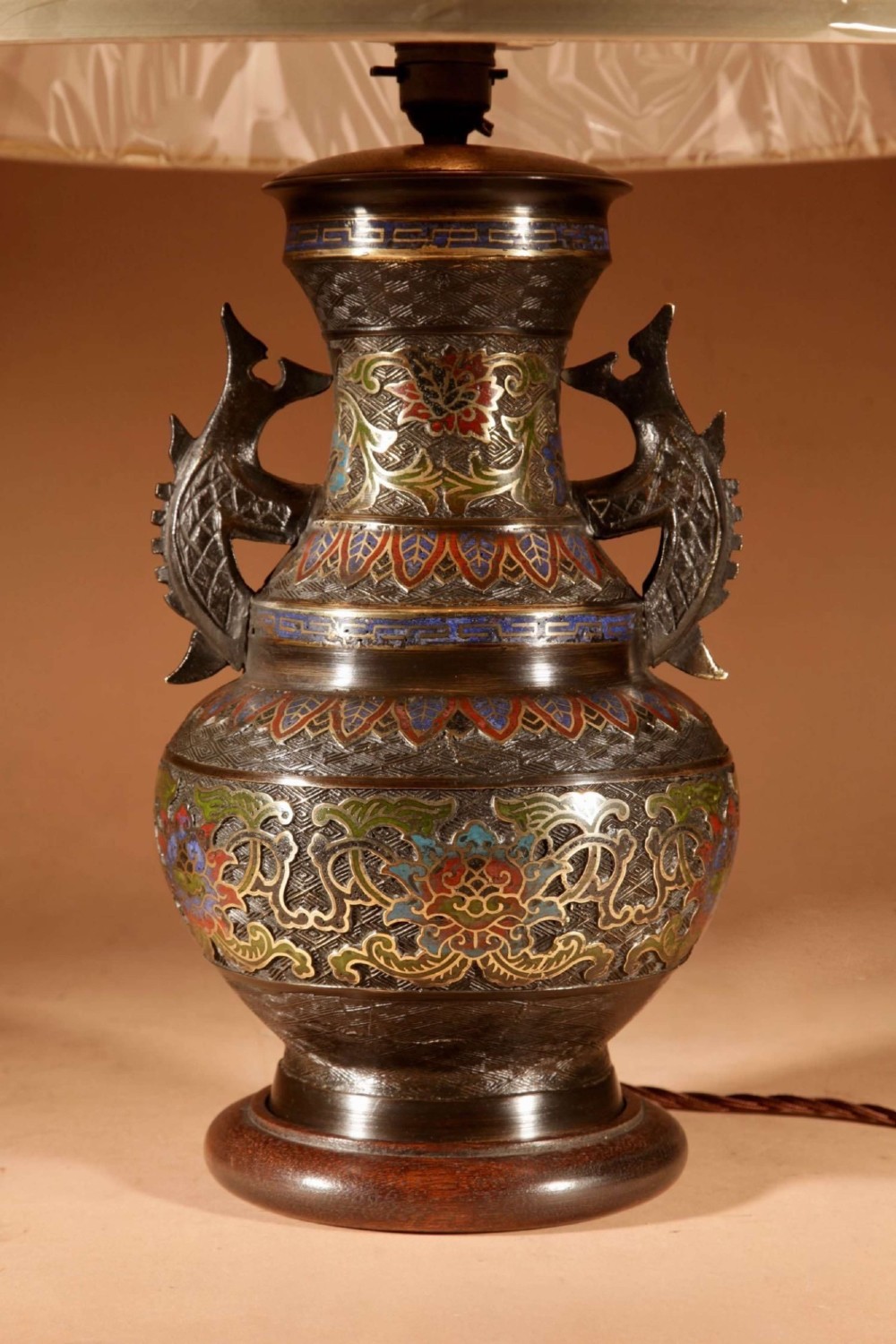 An antique Japanese bronze urn converted into a table lamp, featuring colourful Champleve enamel motifs, twin handles, and a cream pleated shade. View II