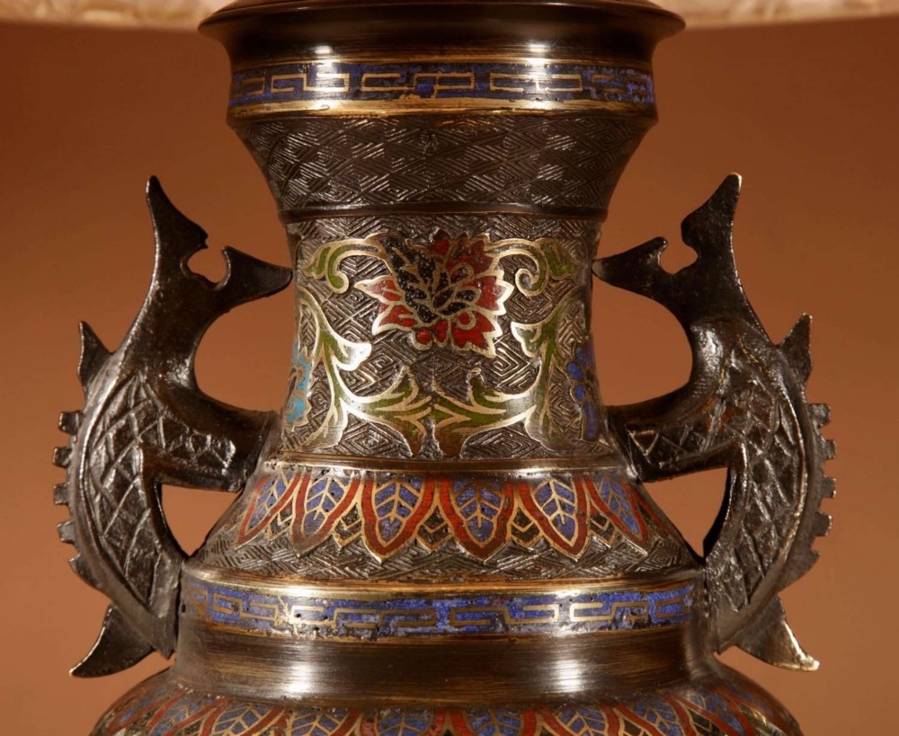 An antique Japanese bronze urn converted into a table lamp, featuring colourful Champleve enamel motifs, twin handles, and a cream pleated shade. View IV