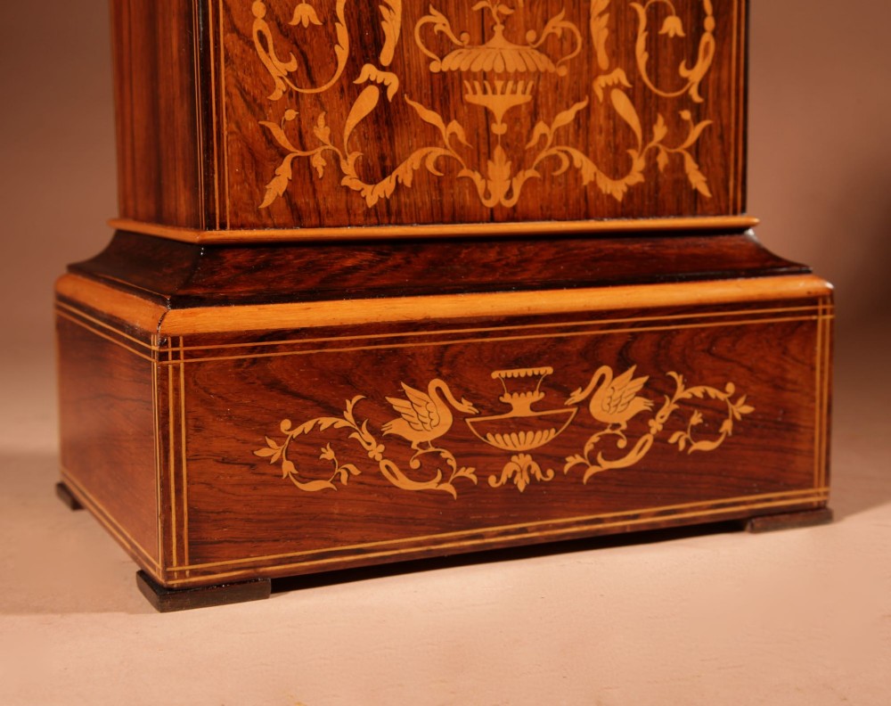 An antique Charles X rosewood mantel clock featuring intricate floral marquetry inlays, a silvered Roman numeral dial, and a decorative cast brass handle on top. View II