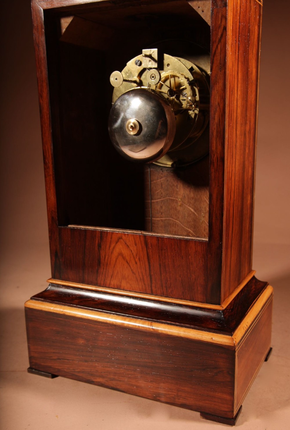 An antique Charles X rosewood mantel clock featuring intricate floral marquetry inlays, a silvered Roman numeral dial, and a decorative cast brass handle on top. View IX