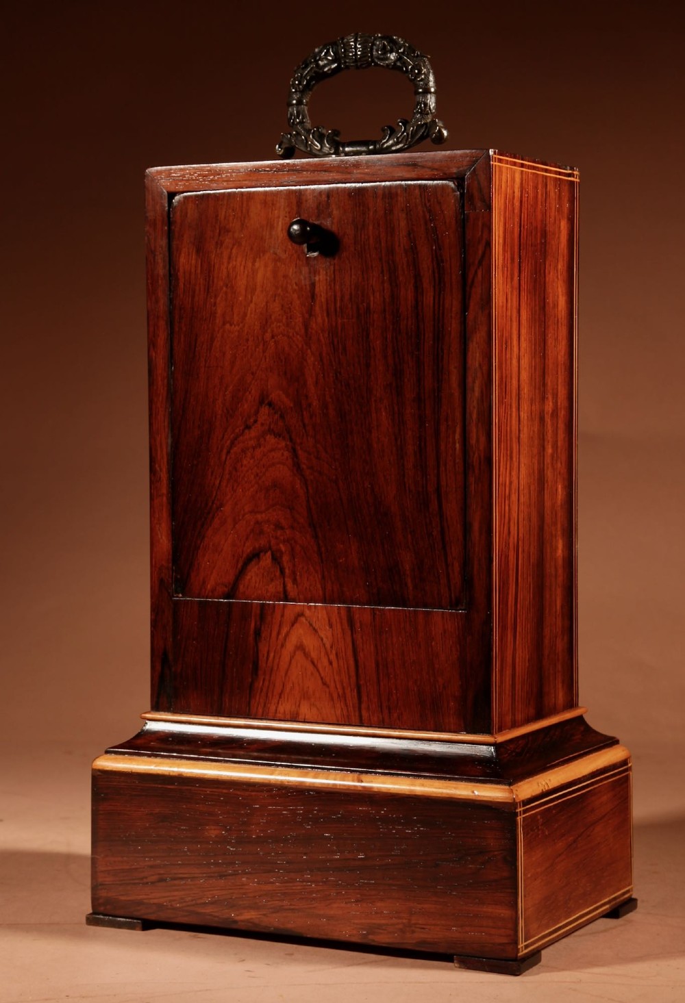 A rectangular Charles X dark rosewood mantel clock featuring intricate floral marquetry inlay, a circular silvered dial with Roman numerals, and a cast brass carrying handle on top. View VII