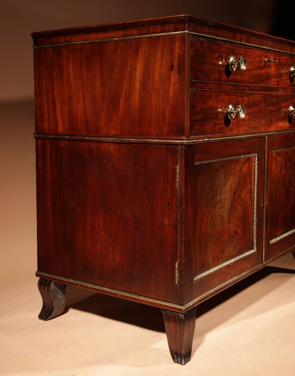 A Regency mahogany library secretaire featuring a pull-out writing drawer with an adjustable slope, brass handles, and lower cabinet doors opening to reveal pull-out tray shelves. View III