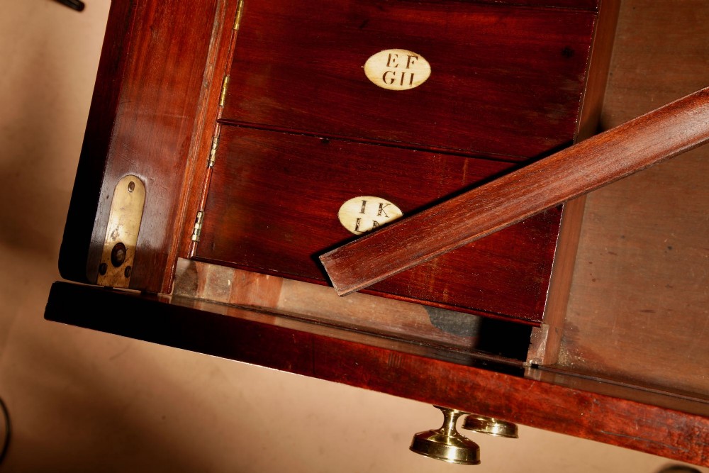 A Regency mahogany library secretaire featuring a pull-out writing drawer with an adjustable slope, brass handles, and lower cabinet doors opening to reveal pull-out tray shelves. View IX