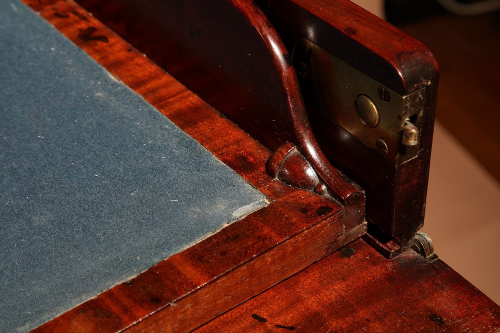 A Regency mahogany library secretaire featuring a pull-out writing drawer with an adjustable slope, brass handles, and lower cabinet doors opening to reveal pull-out tray shelves. View XI