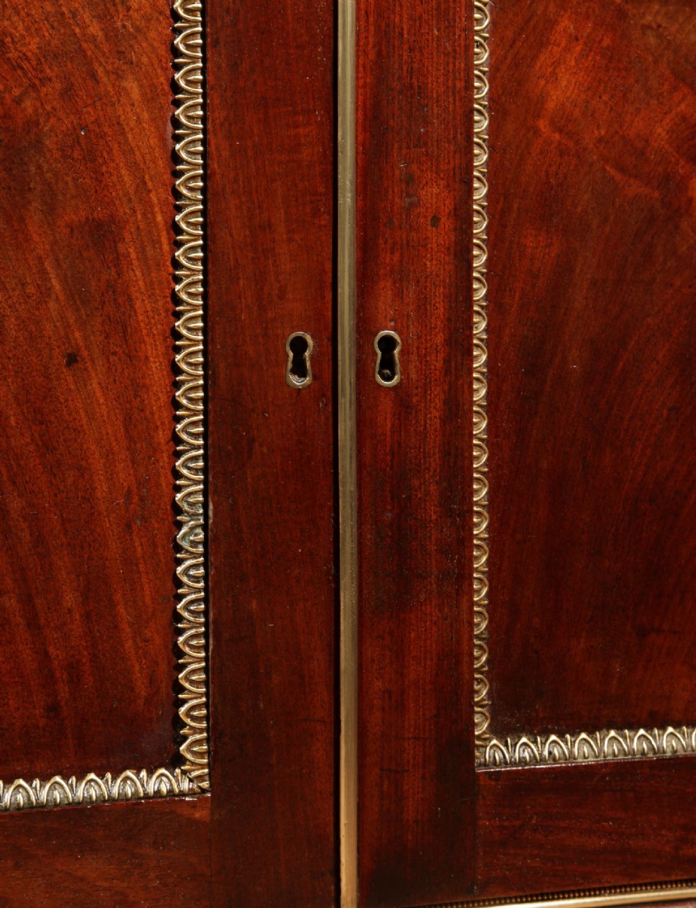 A Regency mahogany library secretaire featuring a pull-out writing drawer with an adjustable slope, brass handles, and lower cabinet doors opening to reveal pull-out tray shelves. View XII