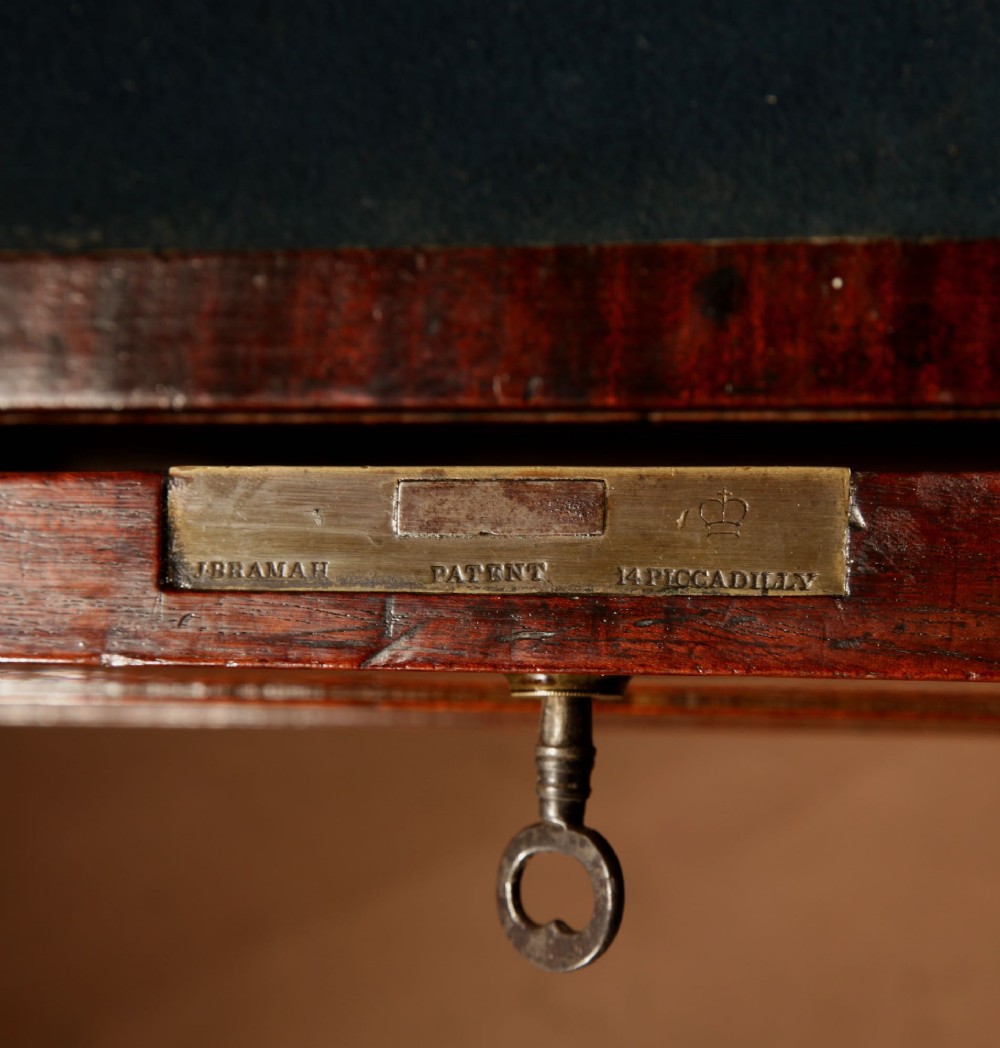 A Regency mahogany library secretaire featuring a pull-out writing drawer with an adjustable slope, brass handles, and lower cabinet doors opening to reveal pull-out tray shelves. View XIV