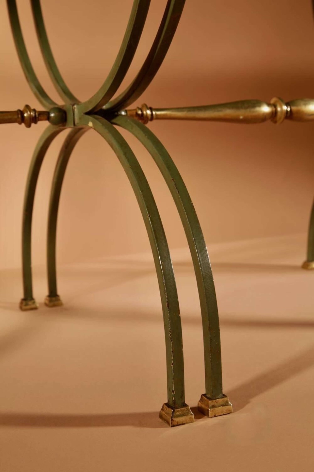 A four-part French Art Deco coffee table constructed from green wrought iron and brass with mirrored glass inserts featuring star motifs. View V