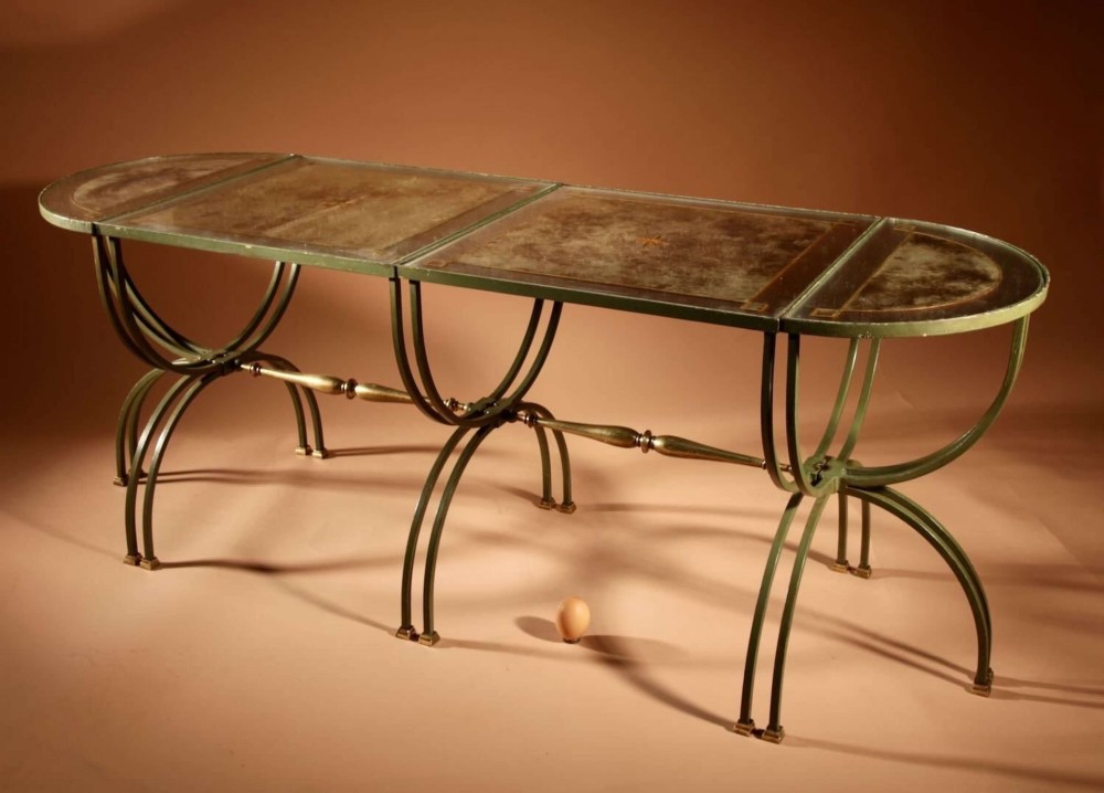 A four-part French Art Deco coffee table constructed from green wrought iron and brass with mirrored glass inserts featuring star motifs. View VII