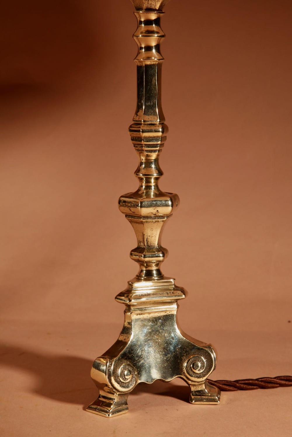 A pair of cast brass table lamps featuring turned baluster shafts, scroll-footed bases, and pleated cream fabric shades. View IV