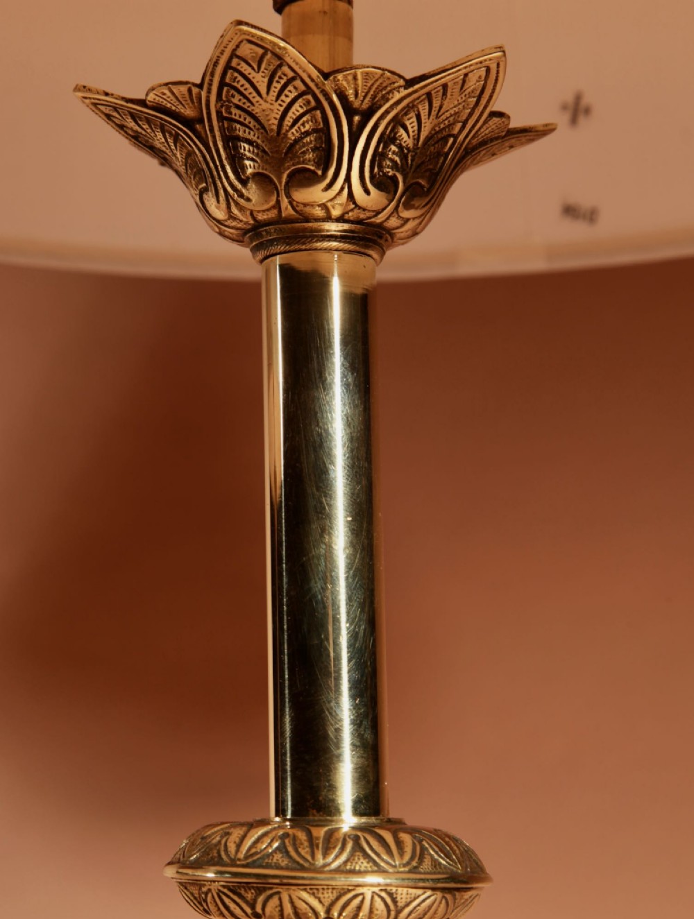 A pair of cast brass table lamps featuring knopped columns, pierced foliage bases, and off-white pleated shades. View III