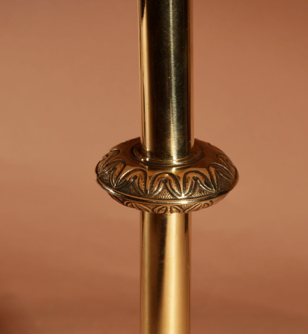A pair of cast brass table lamps featuring knopped columns, pierced foliage bases, and off-white pleated shades. View V
