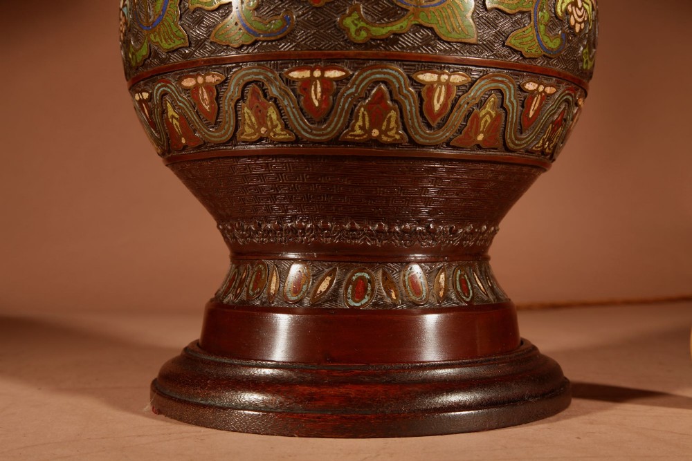 A Japanese champleve bronze vase lamp with ornate scroll handles and polychrome enamel detailing, topped with a pleated white shade. View IV