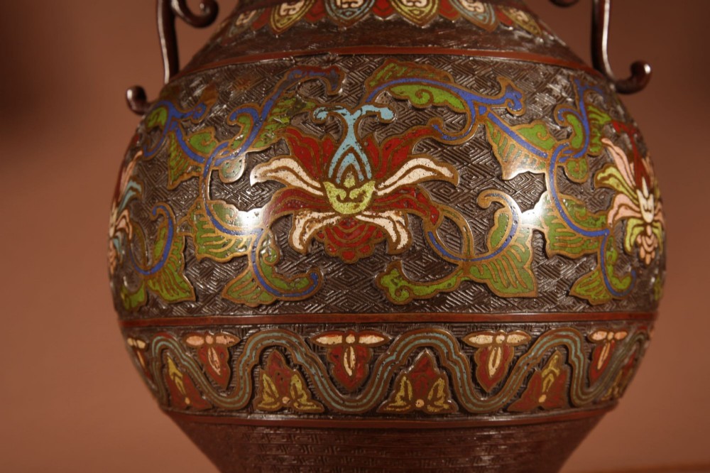 A Japanese champleve bronze vase lamp with ornate scroll handles and polychrome enamel detailing, topped with a pleated white shade. View V