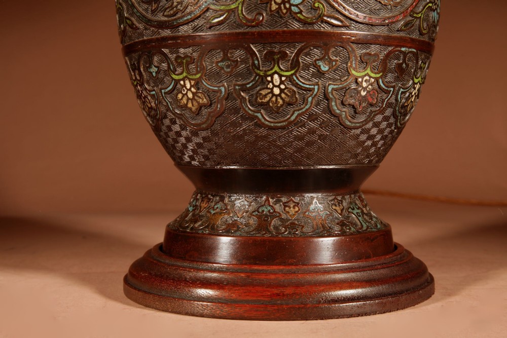 A Japanese champleve bronze vase base featuring cast dragon handles and polychrome enamel roundels, topped with a cream pleated shade. View III