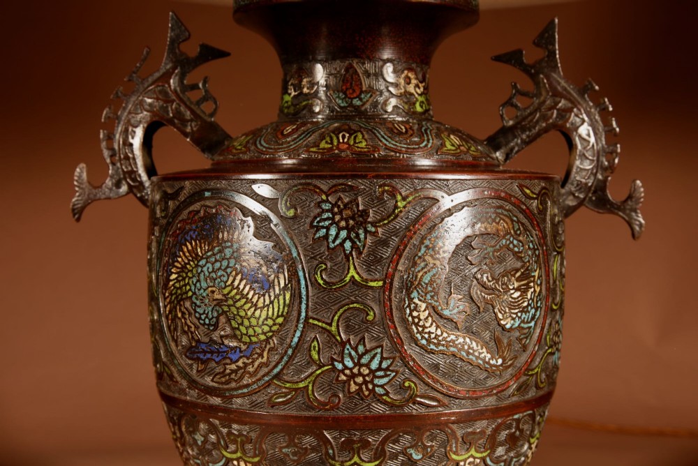 A Japanese champleve bronze vase base featuring cast dragon handles and polychrome enamel roundels, topped with a cream pleated shade. View IV
