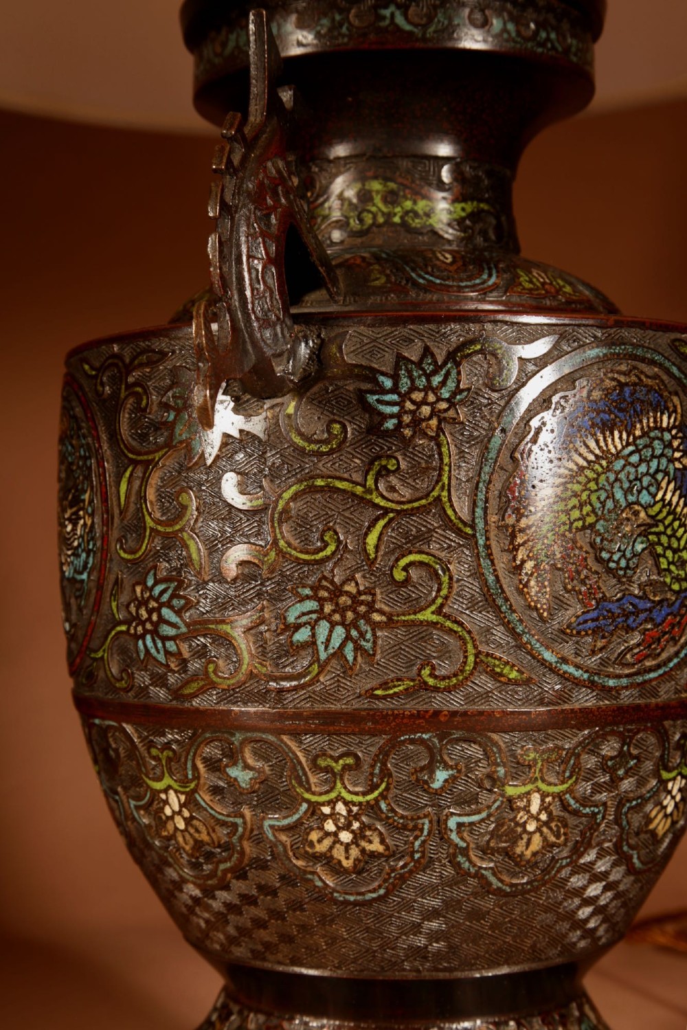 A Japanese champleve bronze vase base featuring cast dragon handles and polychrome enamel roundels, topped with a cream pleated shade. View VI