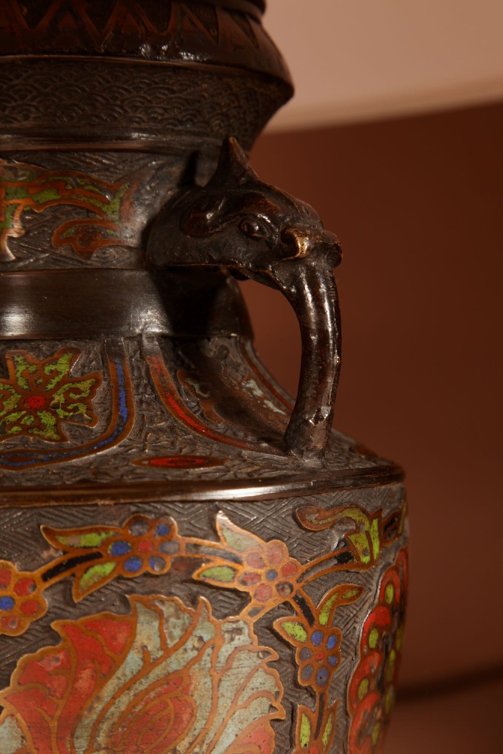 A Japanese champleve bronze urn formatted as a table lamp with polychrome enamel floral patterns, sculpted handles, and a cream pleated shade. View III