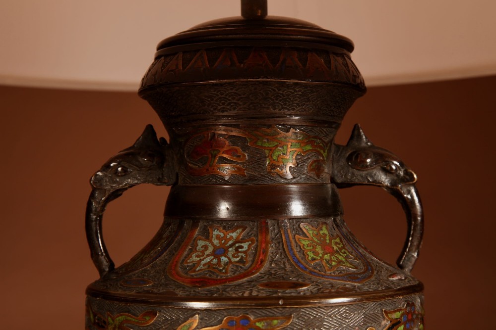 A Japanese champleve bronze urn formatted as a table lamp with polychrome enamel floral patterns, sculpted handles, and a cream pleated shade. View IV