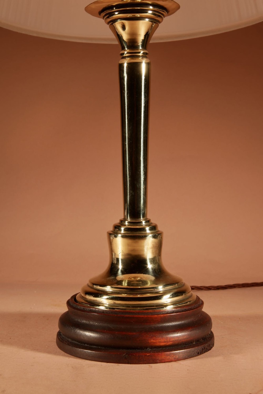 A polished brass column table lamp featuring a turned hardwood base and a cream pleated fabric lampshade. View III