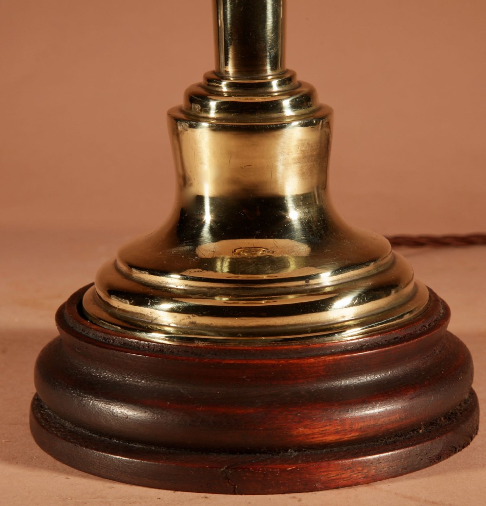 A polished brass column table lamp featuring a turned hardwood base and a cream pleated fabric lampshade. View IV