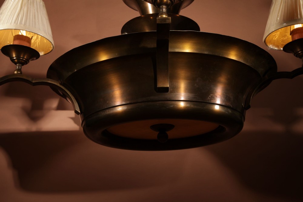 An Amsterdam School bronze five-light chandelier featuring a tiered central column and small pleated lampshades. View V