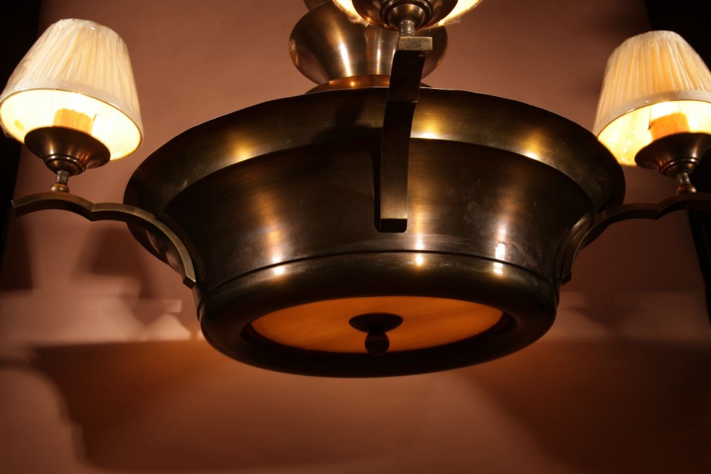 An Amsterdam School bronze five-light chandelier featuring a tiered central column and small pleated lampshades. View VI