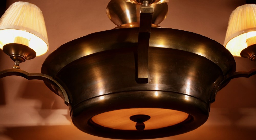 An Amsterdam School bronze five-light chandelier featuring a tiered central column and small pleated lampshades. View VII