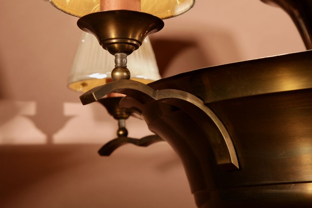 An Amsterdam School bronze five-light chandelier featuring a tiered central column and small pleated lampshades. View XII