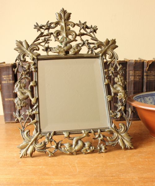 fig 1. French Baroque Brass Wall Dressing Table Easel Back Mirror Decorated with Dolphins.
