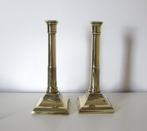 A Pair of Late Georgian Brass Candlesticks