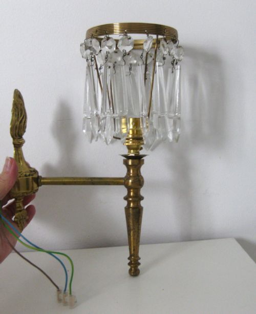 A Set of Three Brass Wall Lights with Crystal Drop Shades