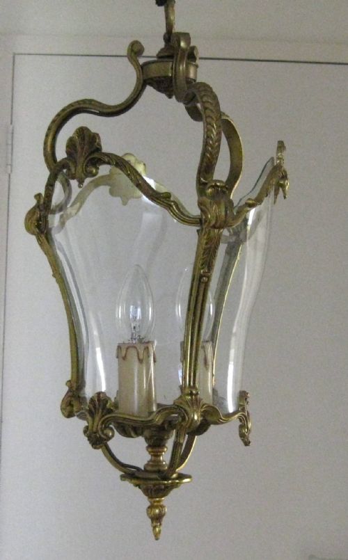 fig 1. AN ANTIQUE BRASS HALL LANTERN WITH CURVED GLASS PANELS