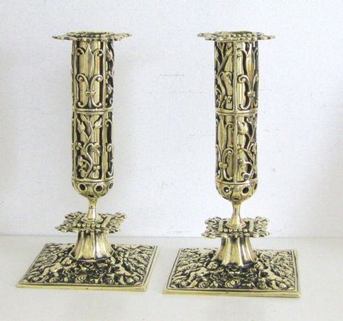 A Pair of Ornate Brass Candlesticks