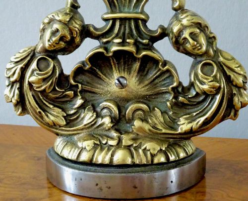 fig 1. BRASS DOORSTOP WITH A SHELL AND CHERUBS