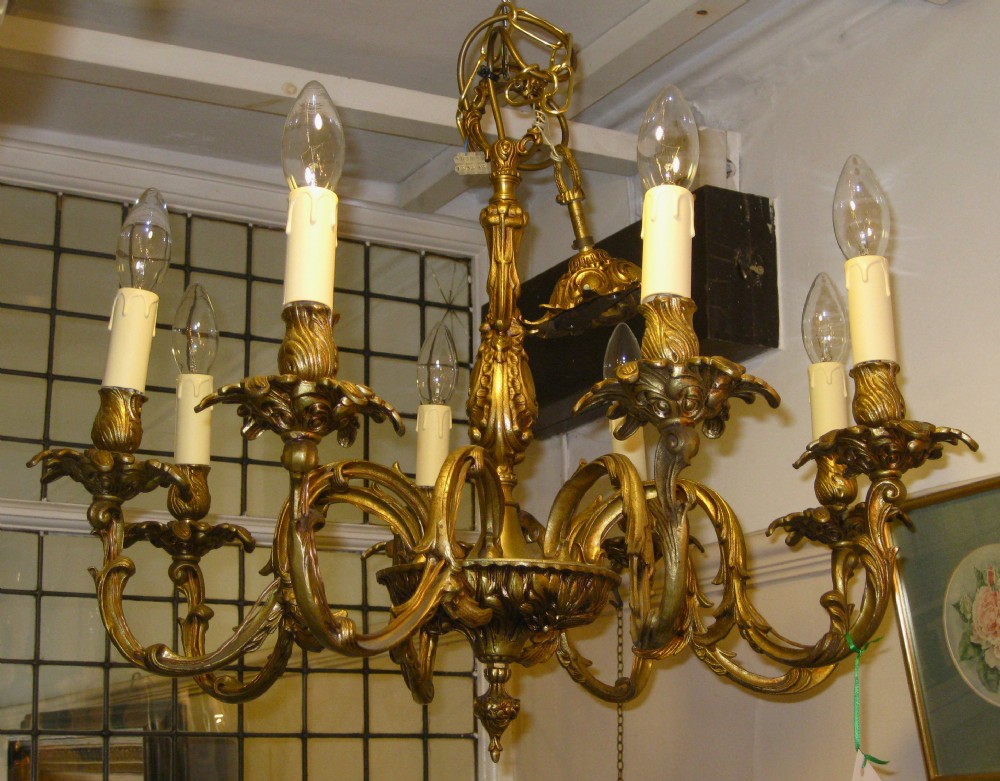 AN EARLY 20THC EIGHT ARM BRASS CHANDELIER