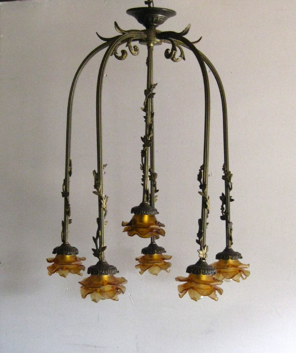 AN ANTIQUE CEILING LIGHT WITH AMBER SHADES