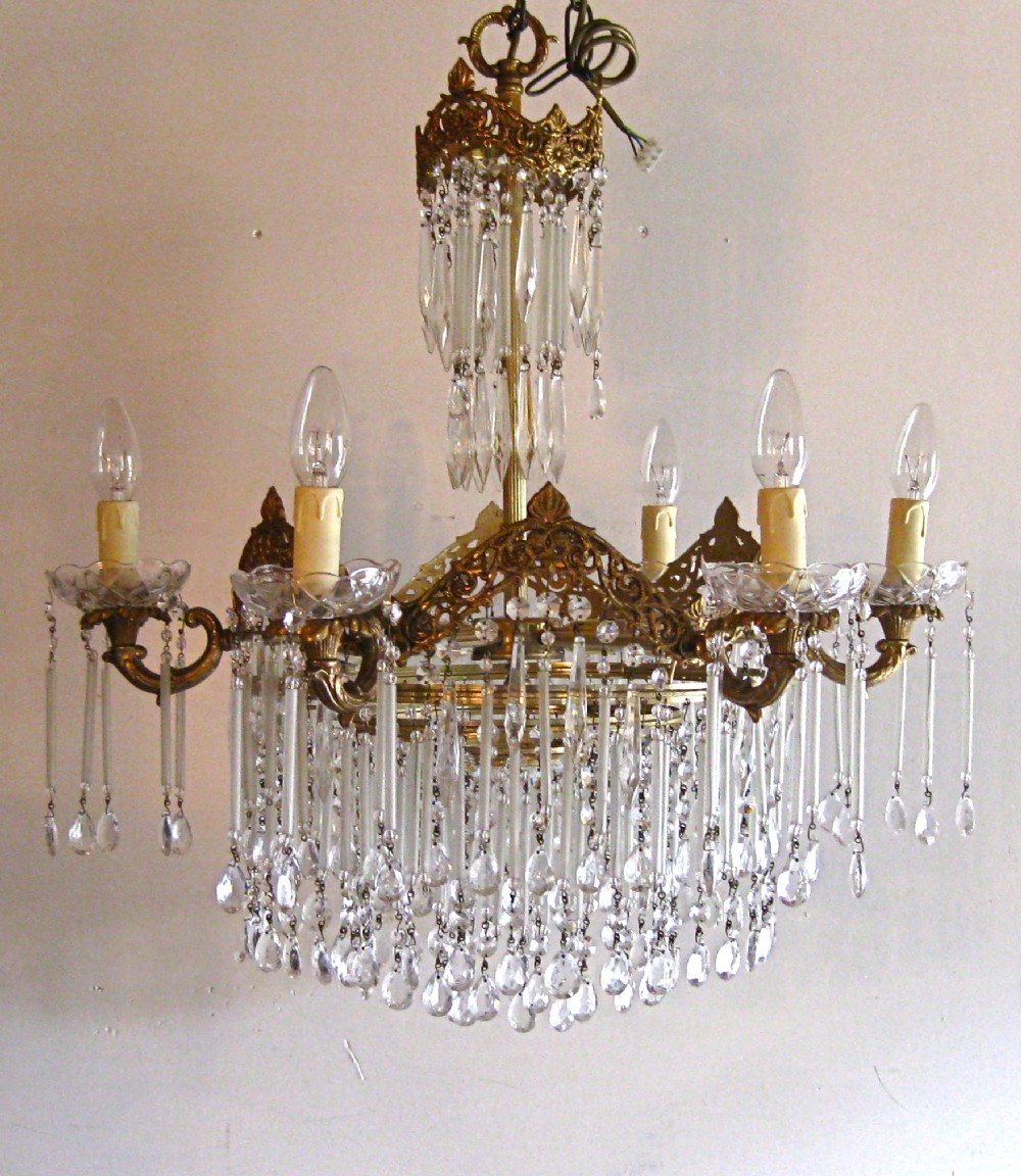 A  BRASS  CHANDELIER WITH LONG FROSTED GLASS DROPS