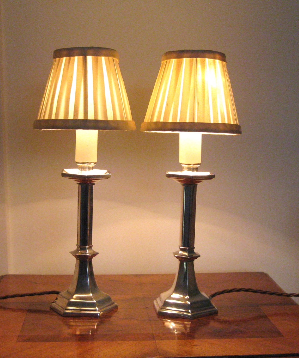 A PAIR OF SILVER PLATED CANDLE LAMPS