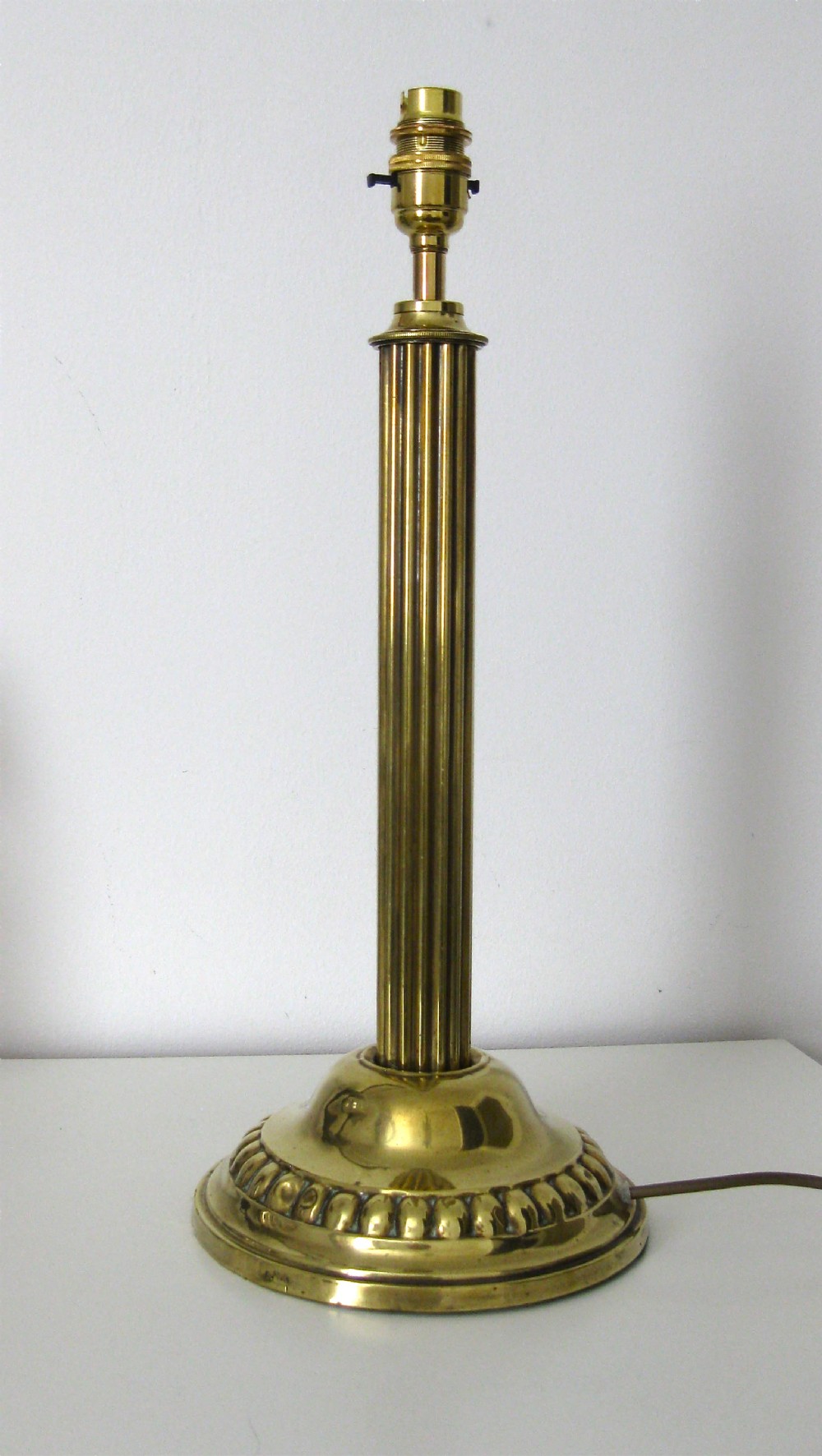 AN EDWARDIAN BRASS LAMP