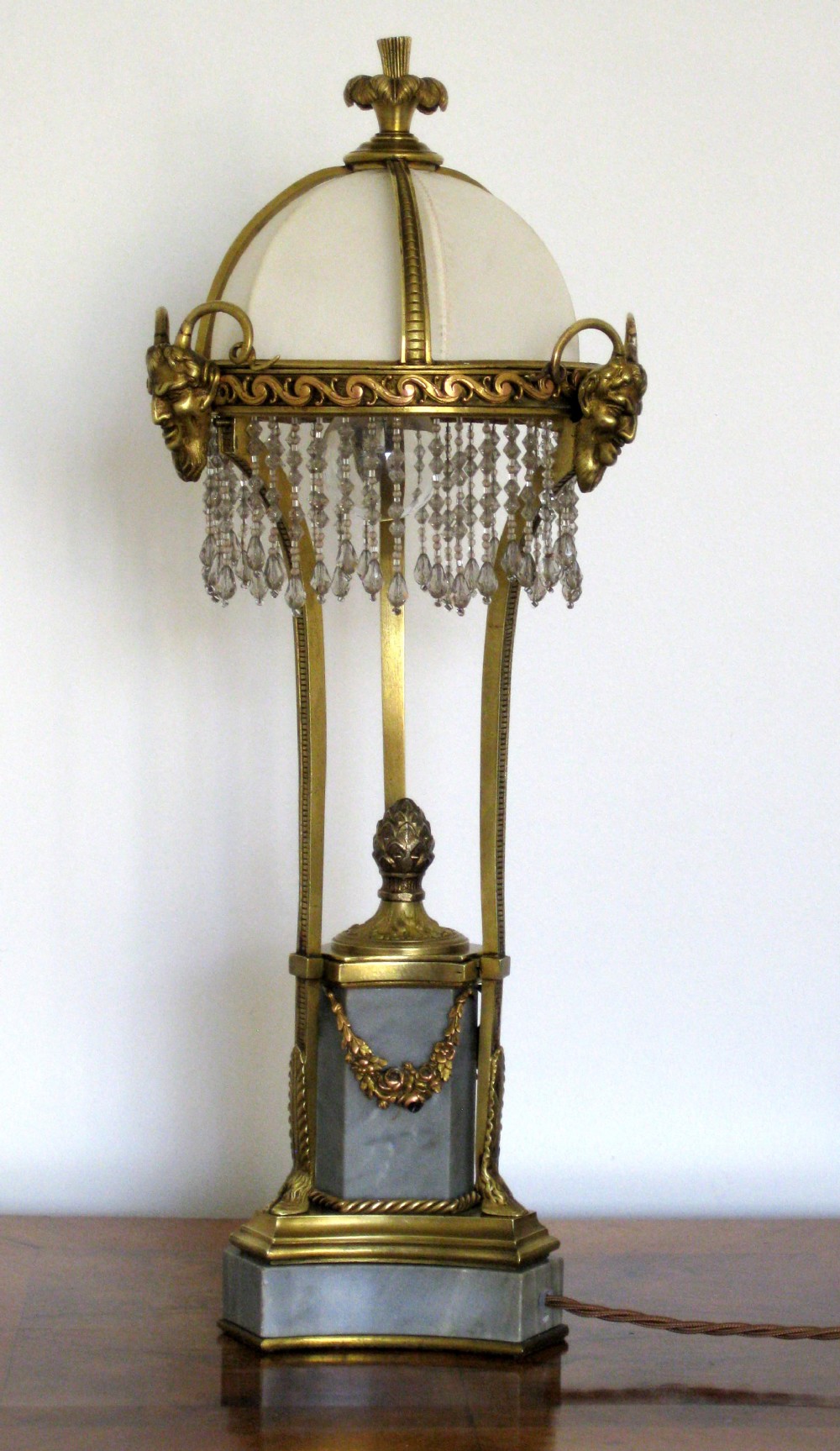 A BRASS AND MARBLE LAMP WITH BEADED SHADE