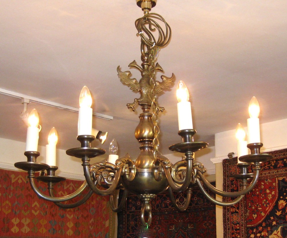 A VICTORIAN BRASS EIGHT ARM CHANDELIER WITH DOLPHINS