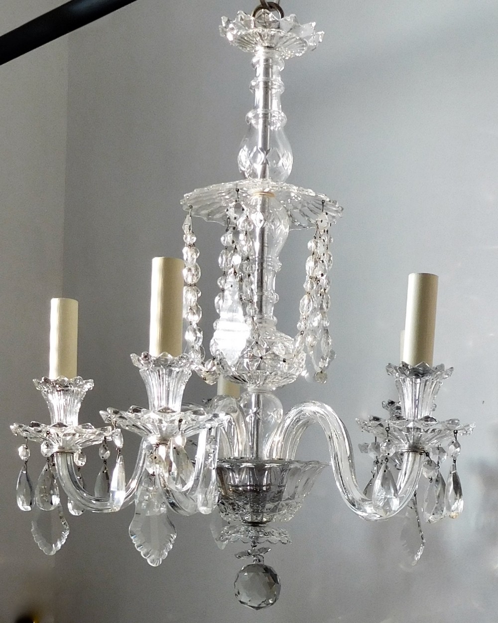 A FIVE ARM CRYSTAL CHANDELIER
