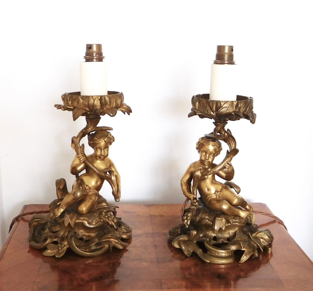 A PAIR OF VICTORIAN GILDED BRONZE CHERUB LAMPS