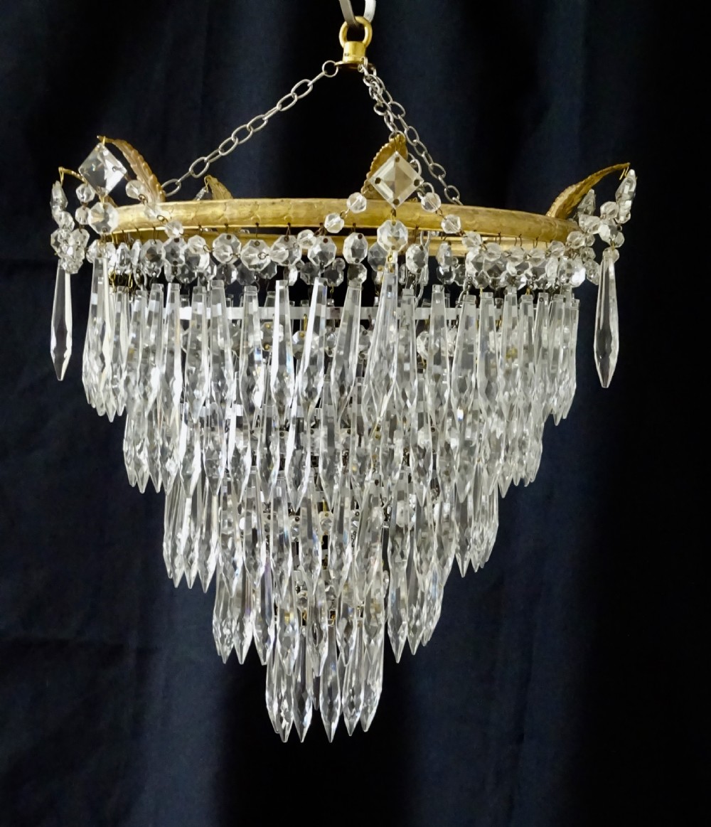 A FIVE TIER GLASS DROP CHANDELIER