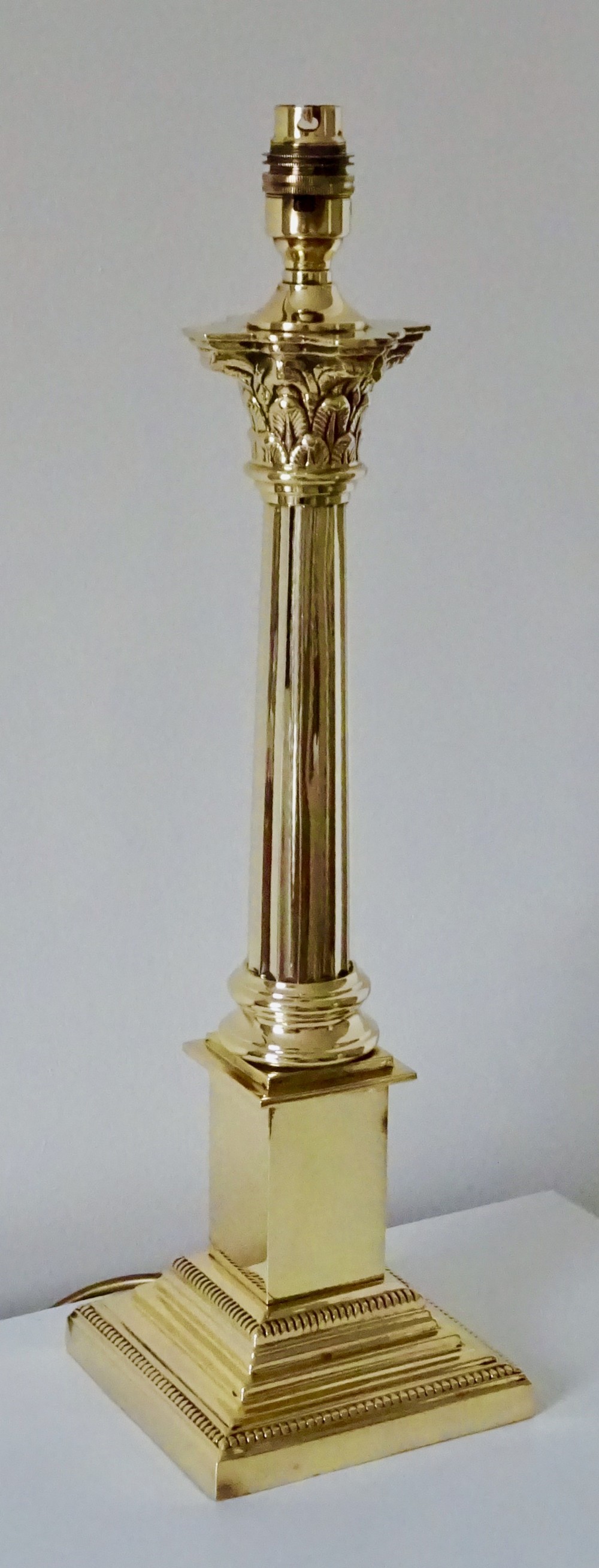 A TALL BRASS CORINTHIAN COLUMN LAMP