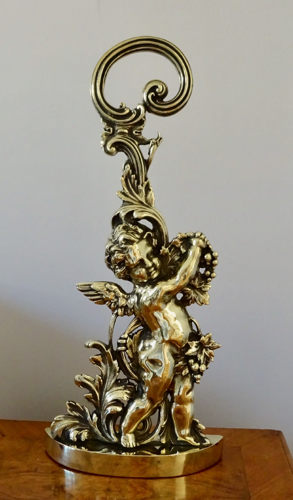 A VICTORIAN BRASS CHERUB DOOR STOP
