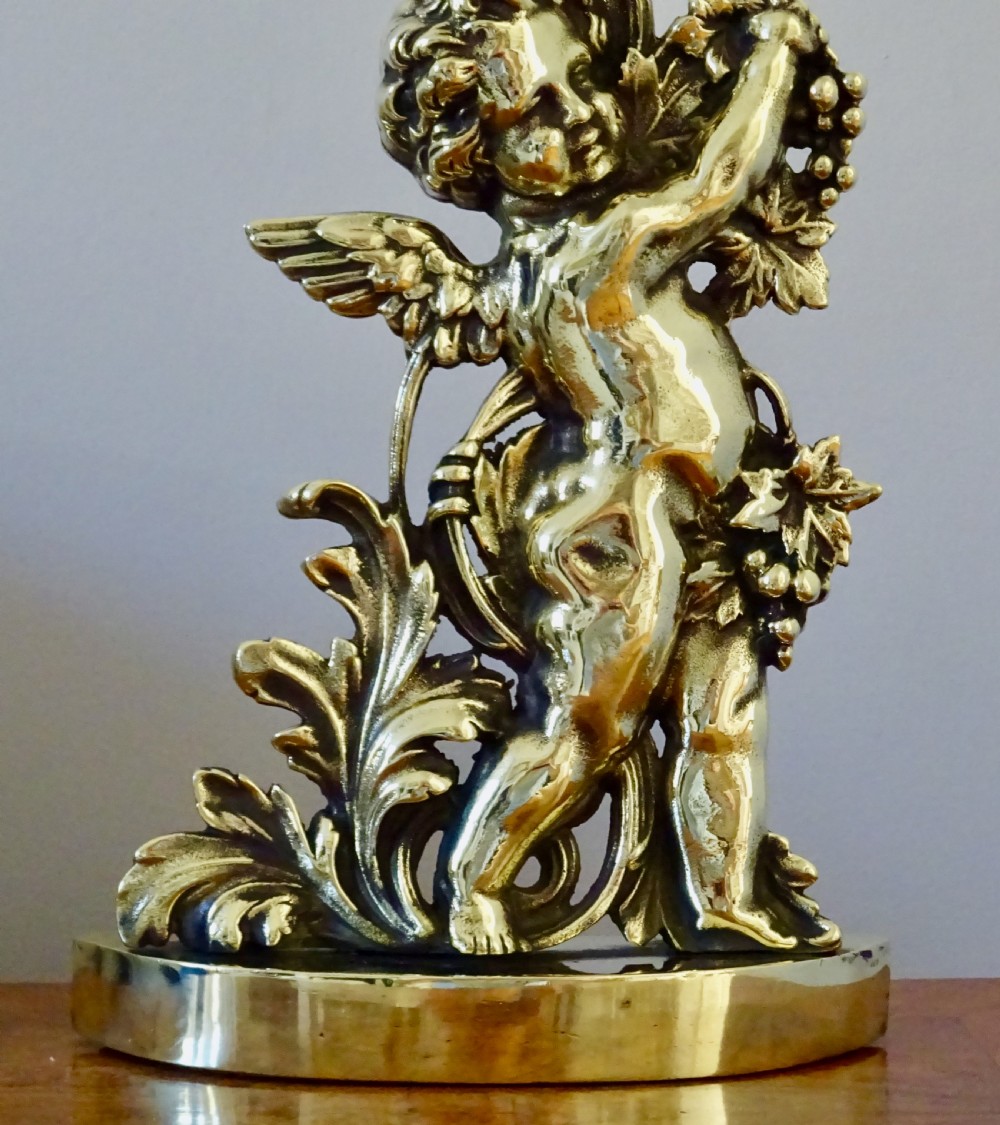 A VICTORIAN BRASS CHERUB DOOR STOP View II