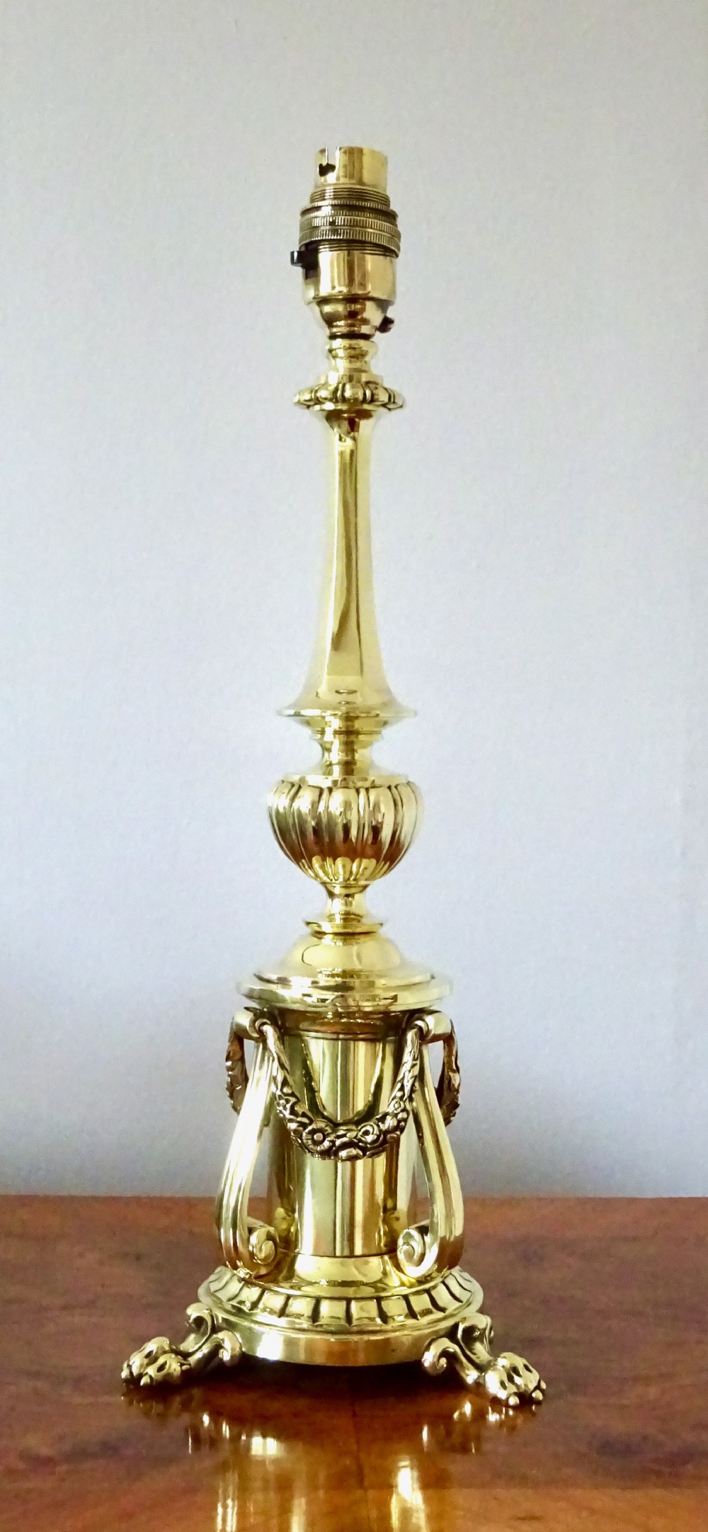 EDWARDIAN BRASS LAMP WITH SWAGS AND LION'S CLAW FEET