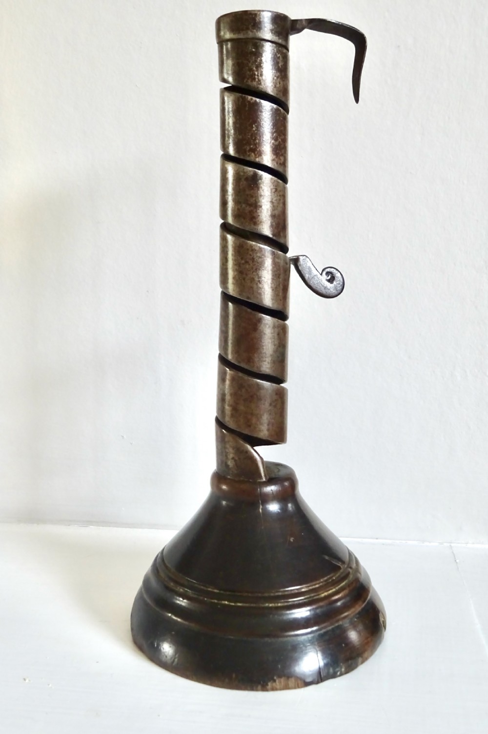 A 19th CENTURY IRON AND WOOD SPIRAL CANDLESTICK
