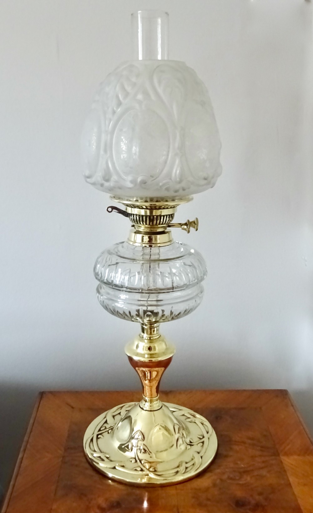 A BRASS, COPPER AND GLASS OIL LAMP
